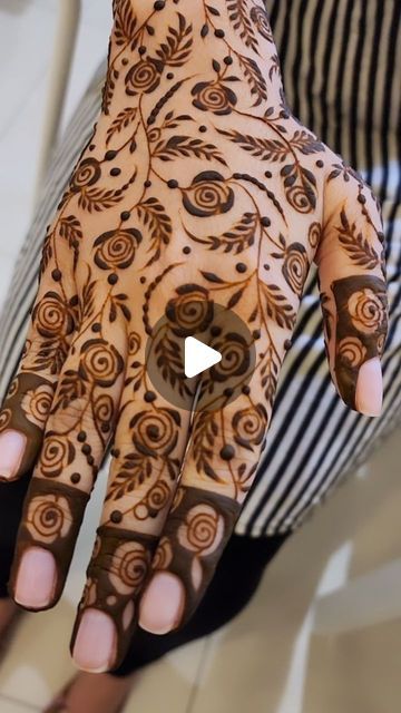 a woman's hand is decorated with hennap and designs on her hands