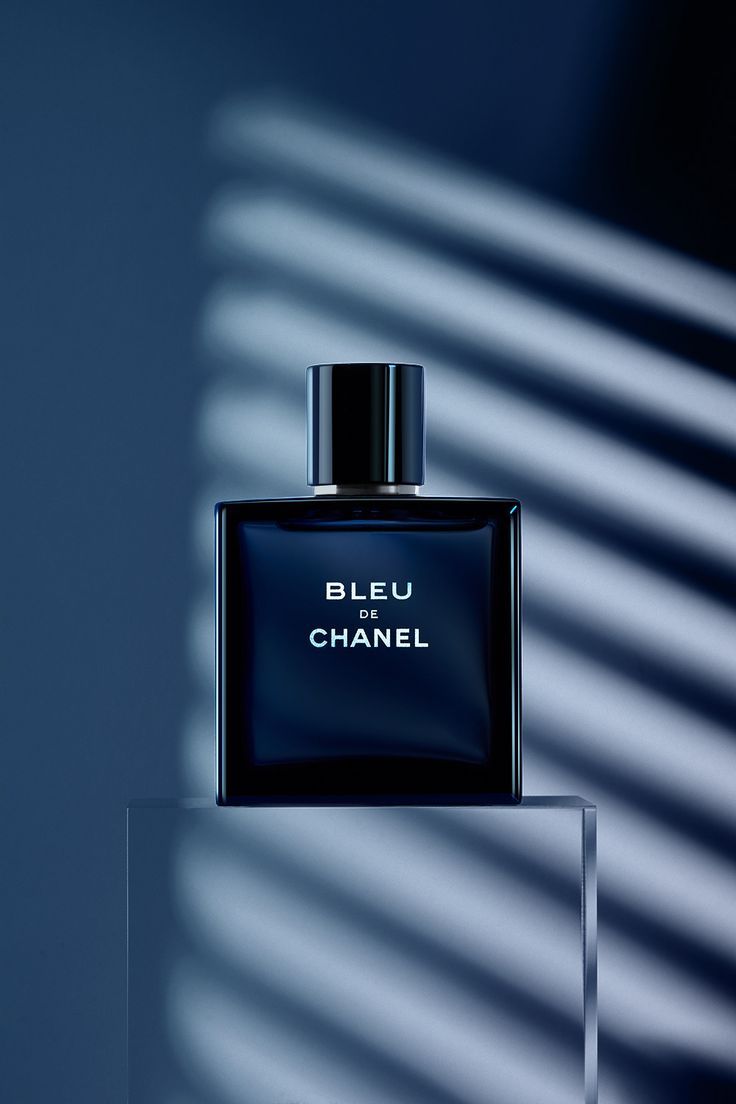 a bottle of blue chanel perfume sitting on top of a table