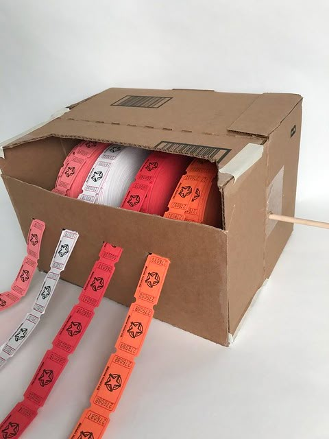 an open box with several rolls of tape in it