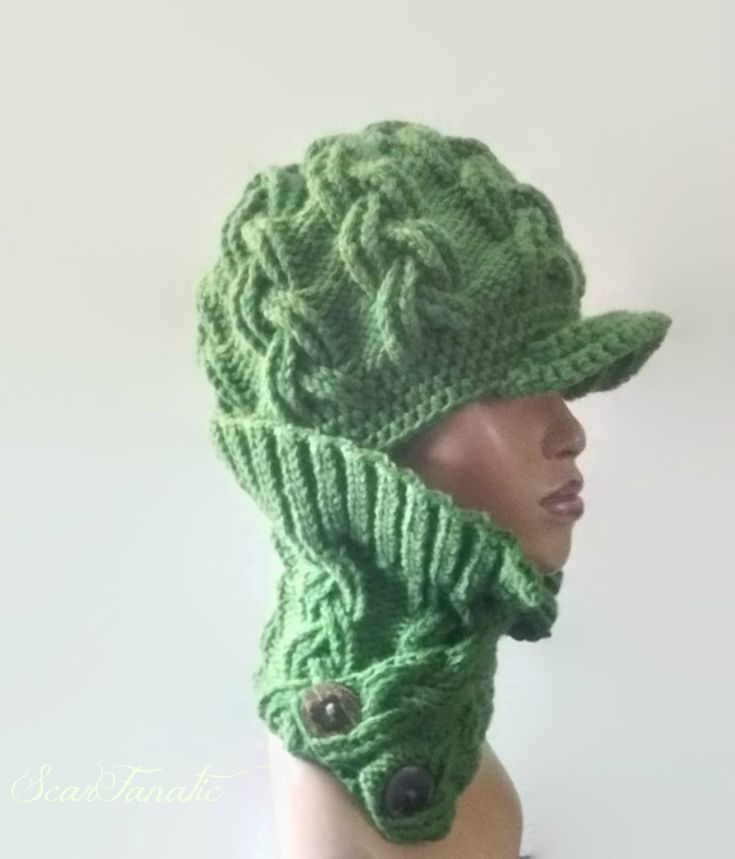 a green knitted hat and scarf on top of a mannequin's head