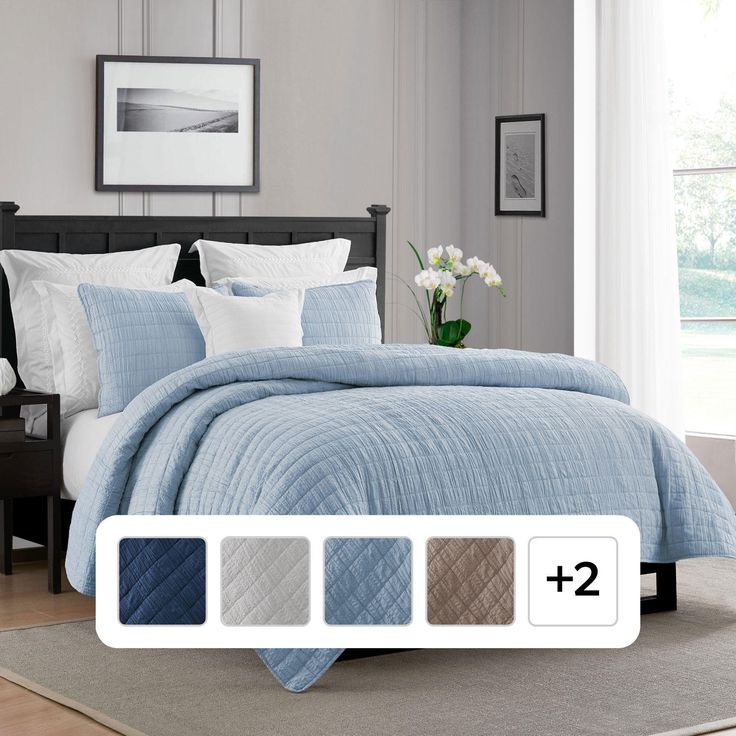 a bed with blue and white bedspread in a bedroom