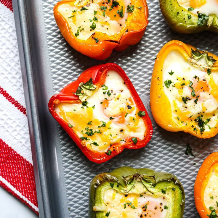 several stuffed peppers are on a baking sheet