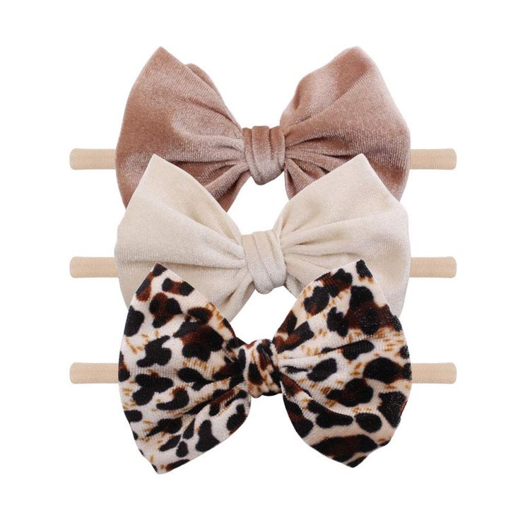 three bow ties on top of each other in different colors and patterns, one with an animal print