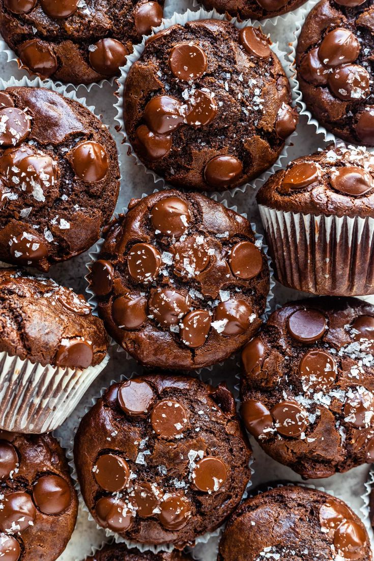 chocolate muffins are piled on top of each other