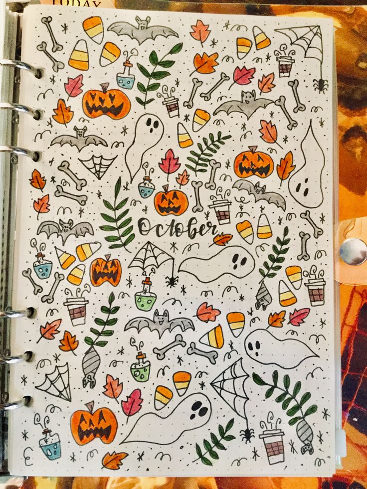 an open notebook with halloween doodles on it