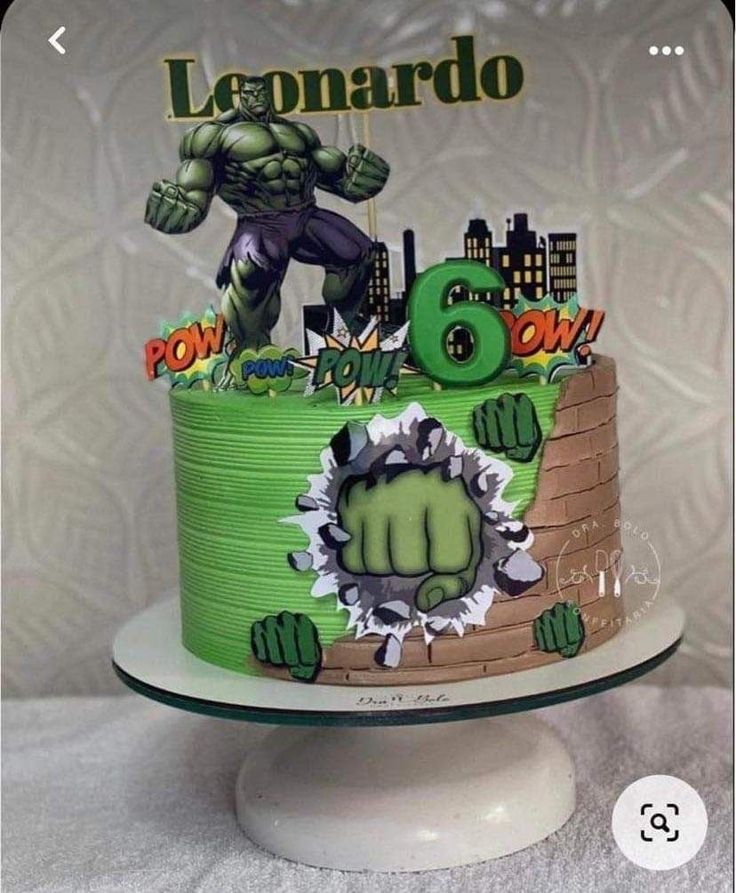 a green cake decorated with an image of the incredible hulk and his monster friend on top