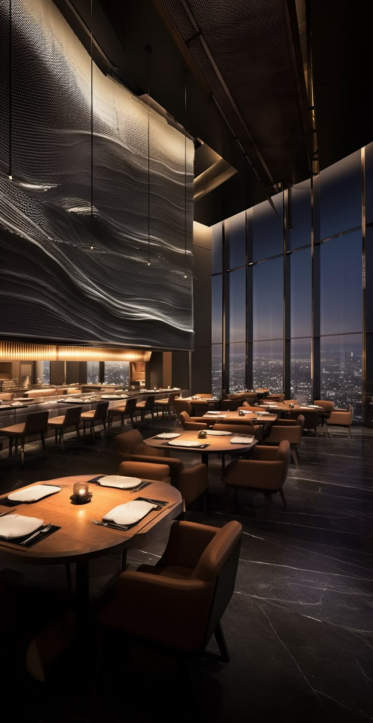 an empty restaurant with tables and chairs in front of large windows overlooking the city at night