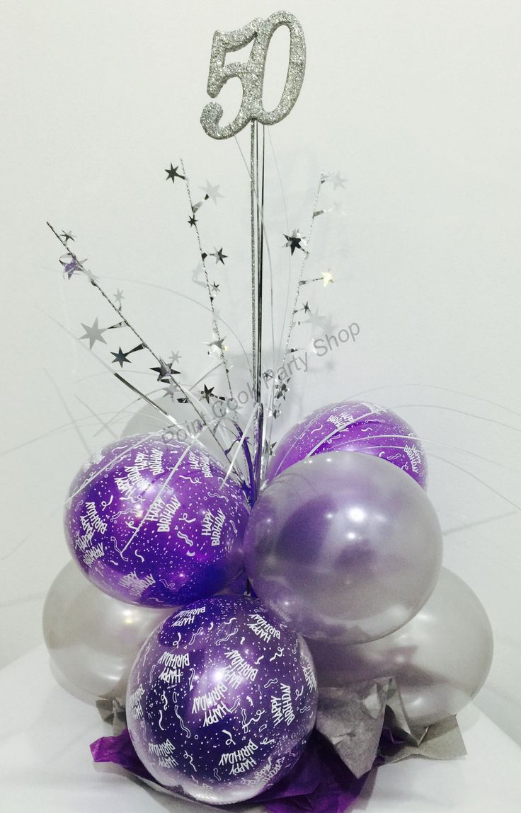 purple and silver balloons are arranged in a vase with the number 50 on it's top