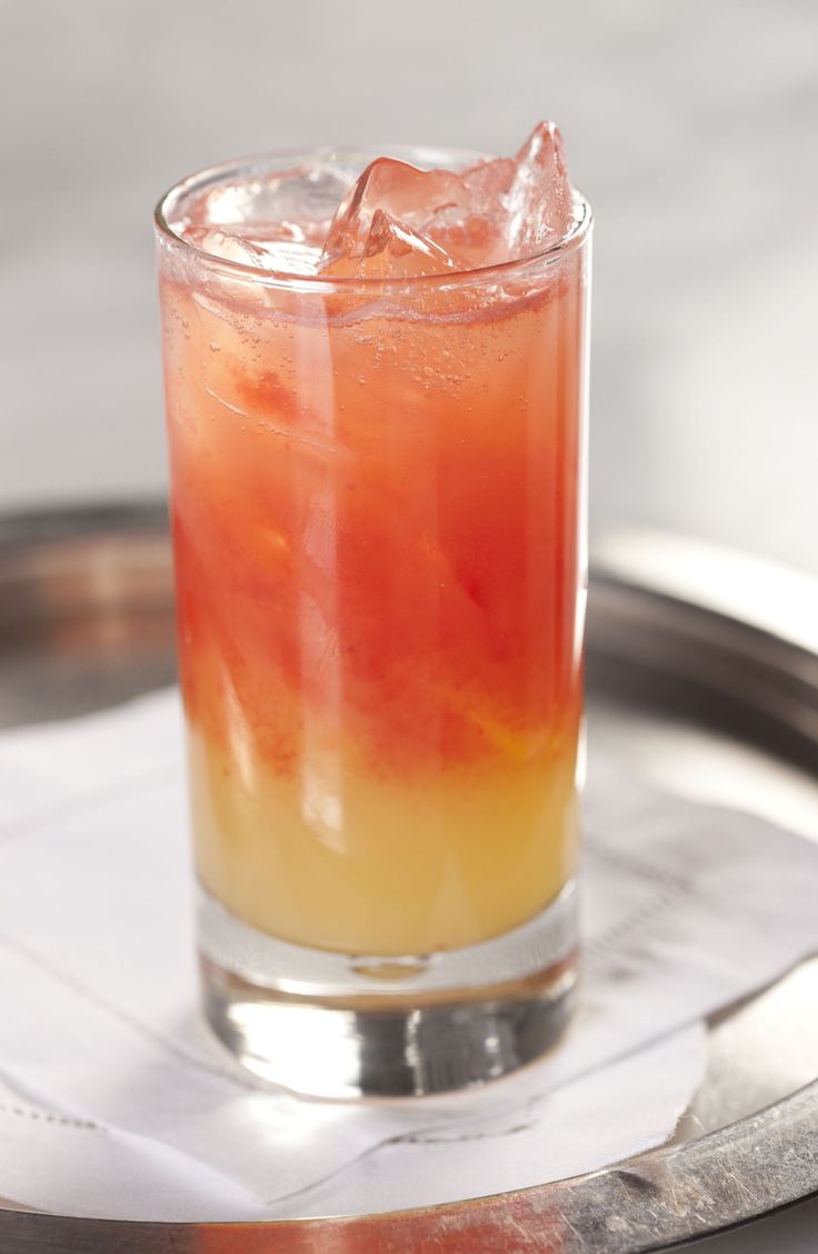 an orange and yellow drink sitting on top of a metal tray