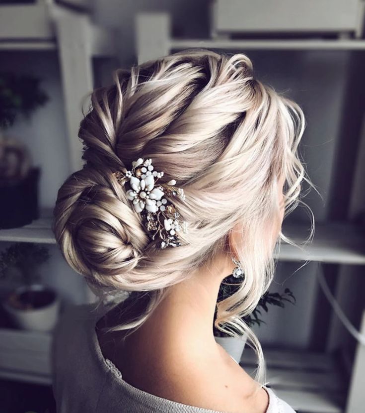 a woman with blonde hair wearing a wedding hairstyle