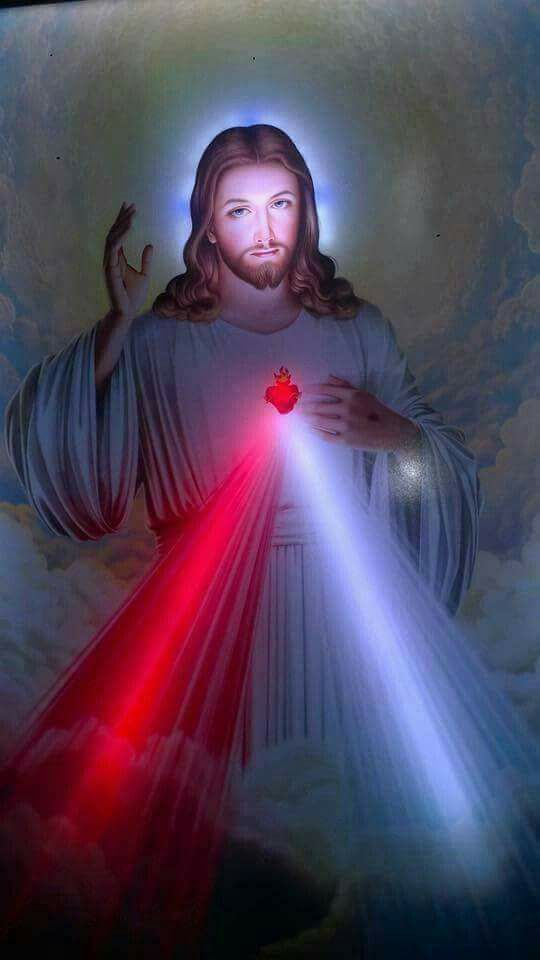 jesus holding a heart in his hands with light beams coming out from the chest and arms