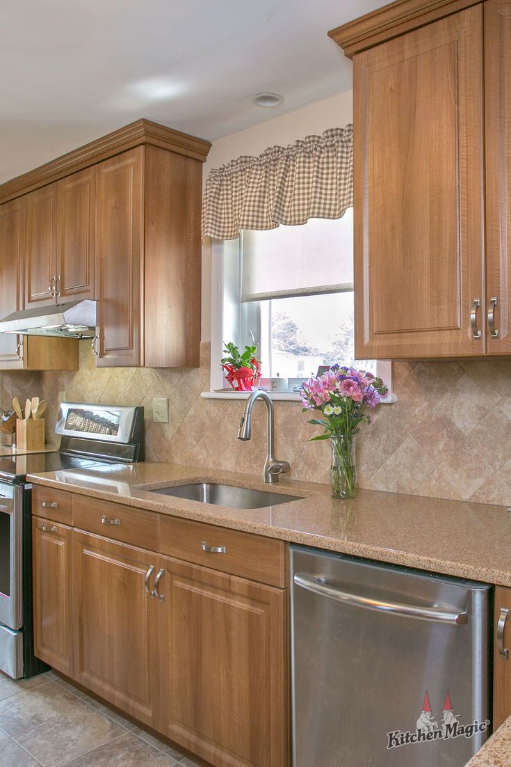 a kitchen with wooden cabinets and stainless steel appliances