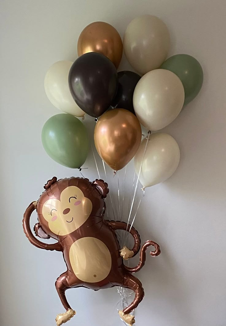 a bunch of balloons that are in the shape of a monkey with a balloon attached to it