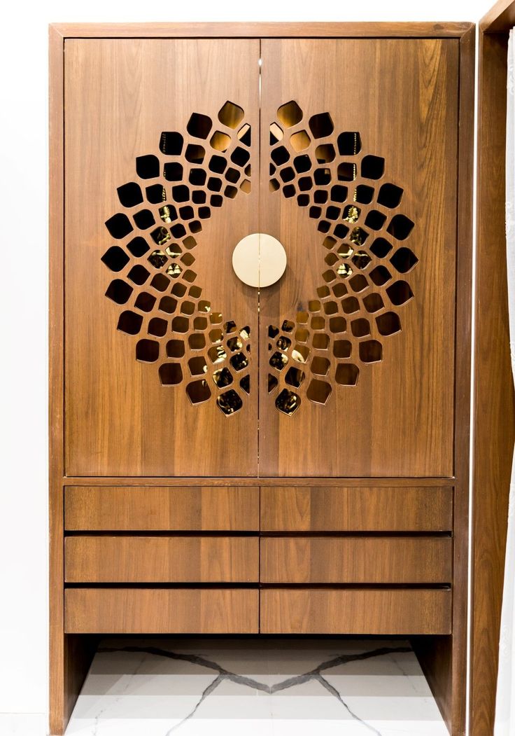 a wooden cabinet with an intricate design on it