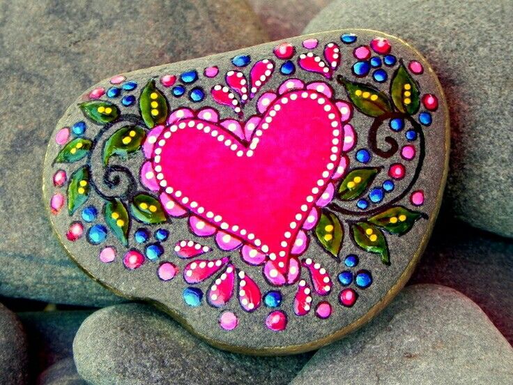 a rock with a pink heart painted on it