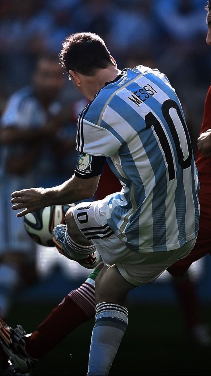 two men are playing soccer on a field