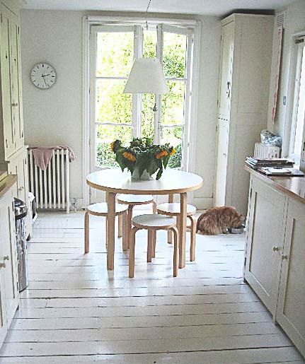 a kitchen with a table and chairs in it