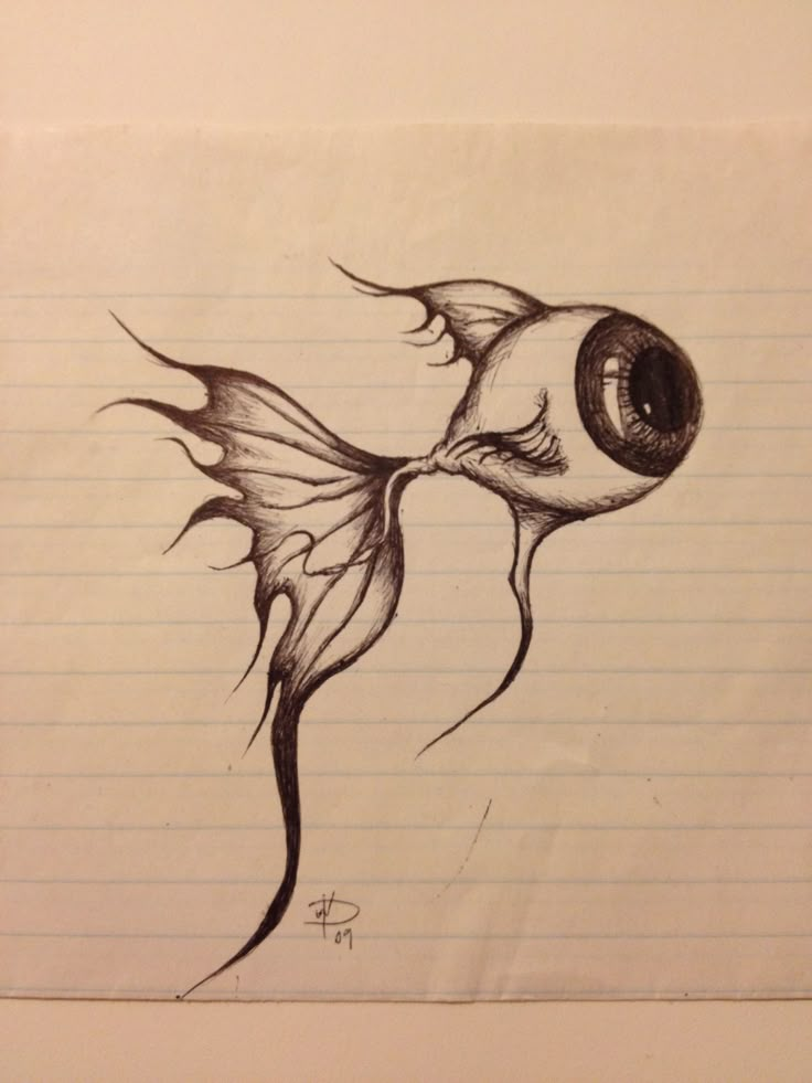 a drawing of a fish with an eye on it's head and tail, sitting on lined paper