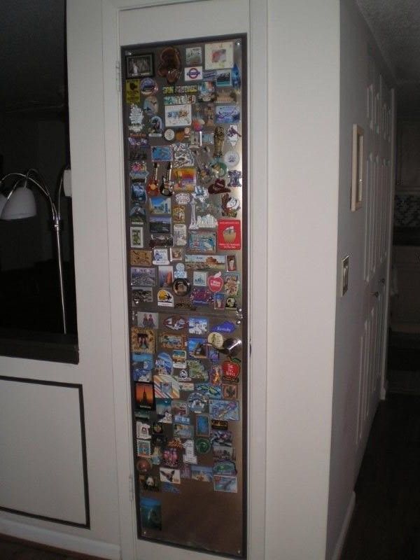 the door is covered with many different pictures and magnets on it's side