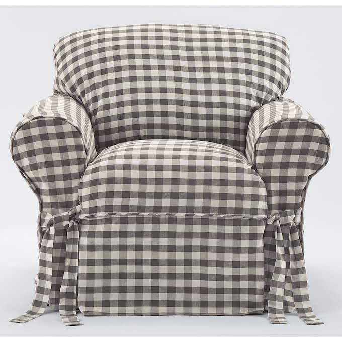 a black and white checkered chair with ties on the armrests, sitting in front of a gray background