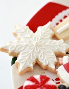 decorated cookies and other holiday treats on a plate