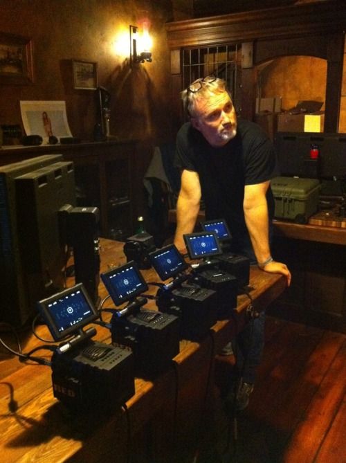 a man standing in front of many electronic devices