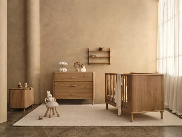 a baby's room with two cribs and a dresser