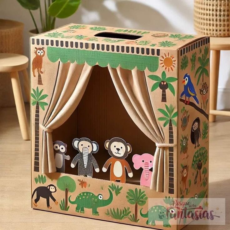 a cardboard box with animals and trees on the inside, sitting on a wooden floor