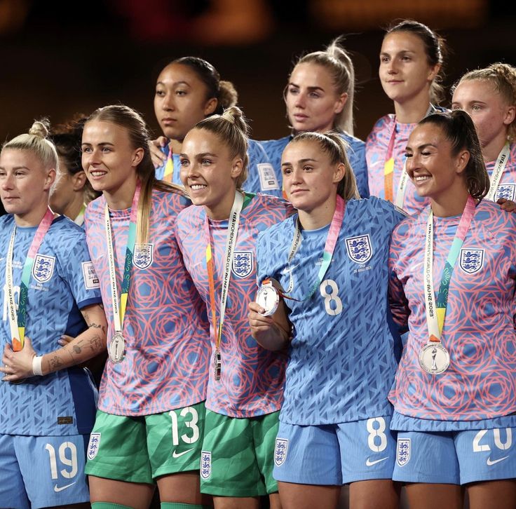 the u s women's soccer team poses for a photo with their gold medals