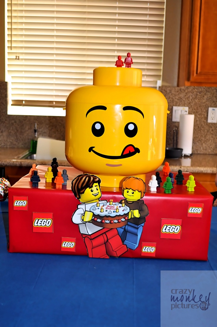 a lego head sitting on top of a red table in front of a blue counter