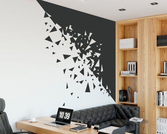 a living room with black and white wallpaper, bookshelves and a couch