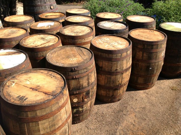 several wooden barrels lined up on the ground