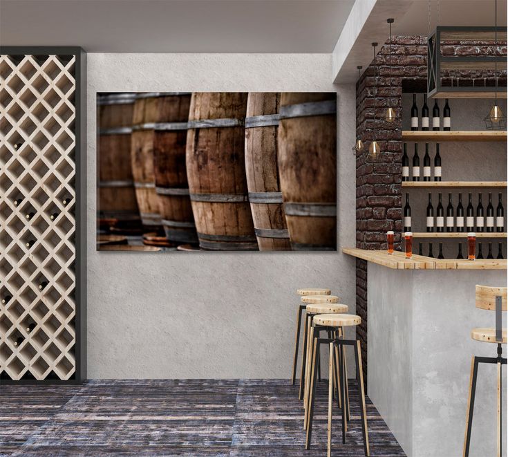 a wine cellar with wooden barrels and bottles on the wall