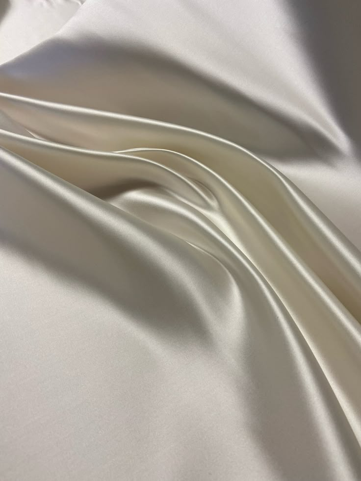 This beautiful white Bridal Satin fabric is perfect for all of your formal garment projects. Imagine the most beautiful wedding dress in this expensive nonstretch Satin.  This fabric is recycled and it is the excess of a previous project. The total amount of fabric is 3 yards available.  Priced per listing per yard. You can get this fabric cut per yard.  Please note:  If you would like to purchase all 3 yards of fabric, you can send me an email and I'll send you an invoice to purchase the fabric Satin Aesthetic Dress, Elegant Beige Wedding Fabric, Satin Aesthetic, Sustainable Fashion Moodboard, Luxury Sustainable, Backdrop Frame, Most Beautiful Wedding Dresses, The White Rabbit, Aesthetic Dress