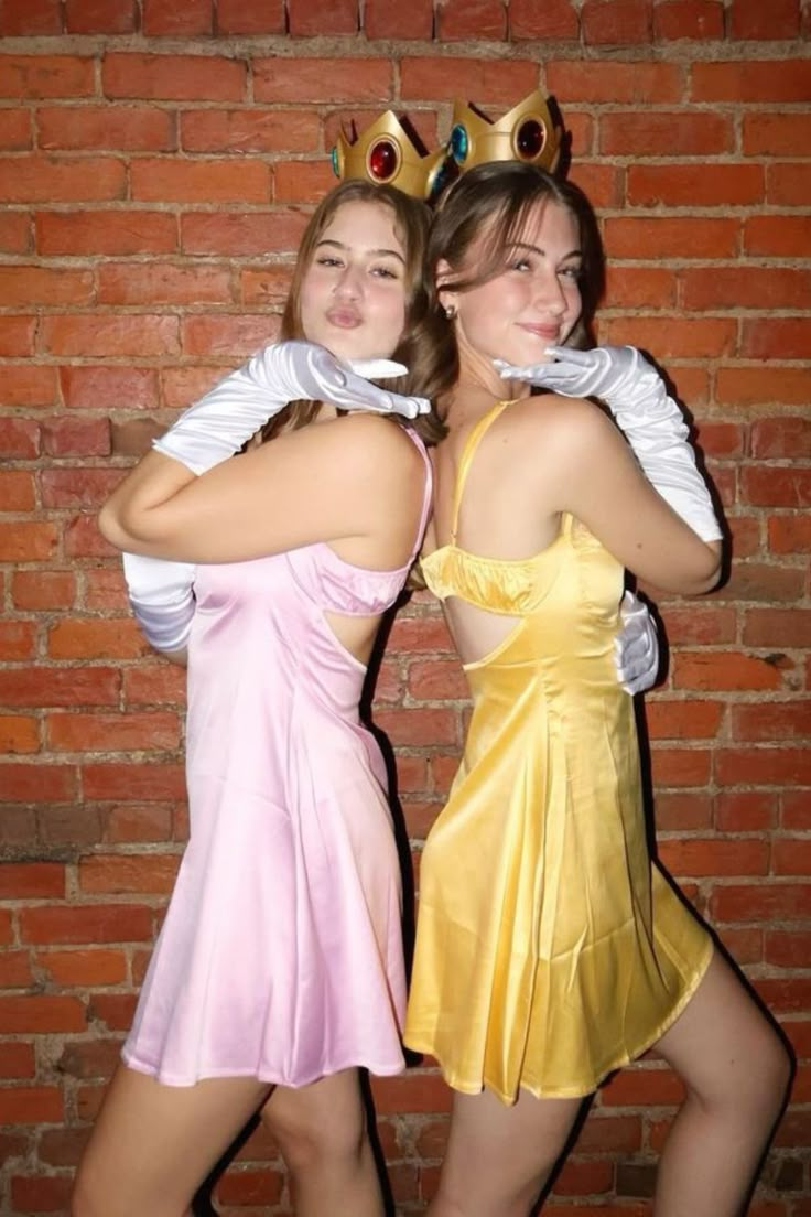 two women dressed in costumes posing for the camera