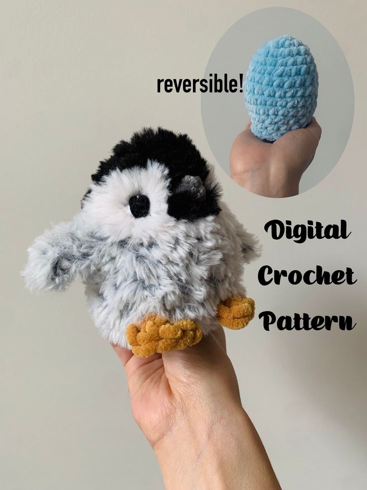 a hand holding a small crocheted penguin