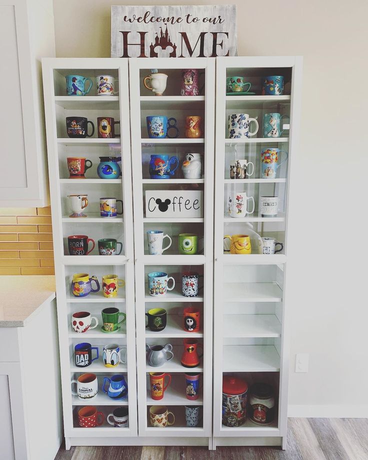 two tall white shelves filled with coffee mugs