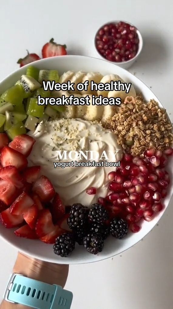 a bowl filled with fruit and yogurt on top of a white countertop