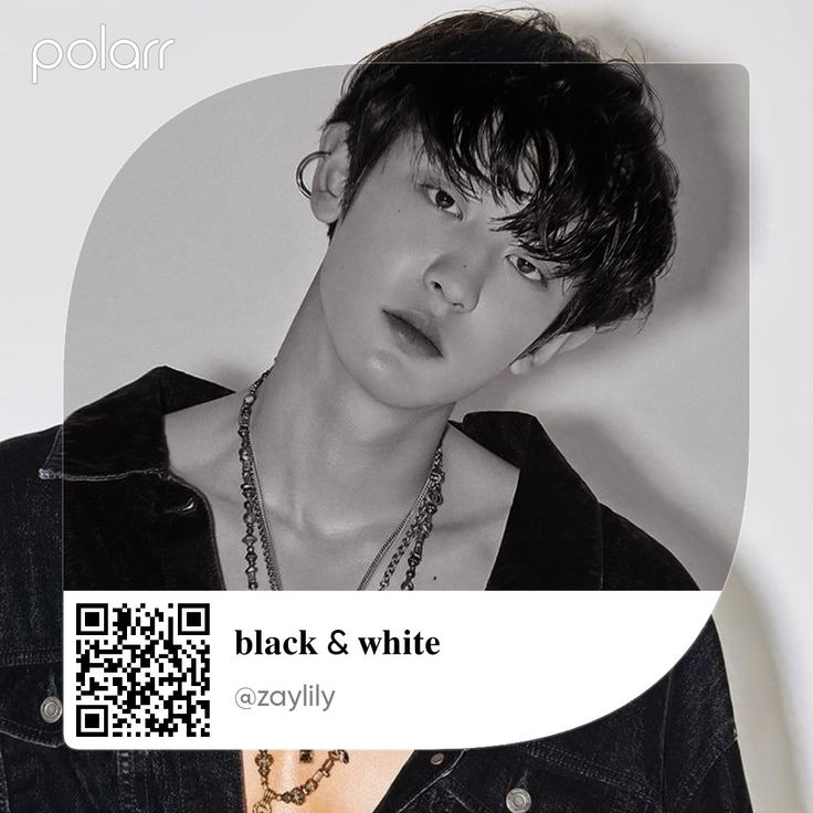 black and white photo of a young man wearing a necklace with qr code on it