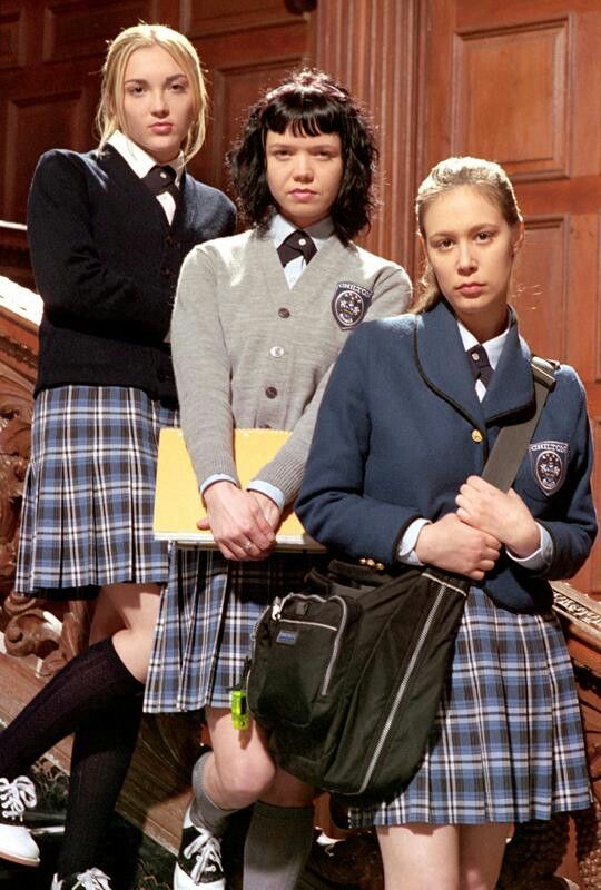 three girls in school uniforms posing for the camera with their hands on their hipss