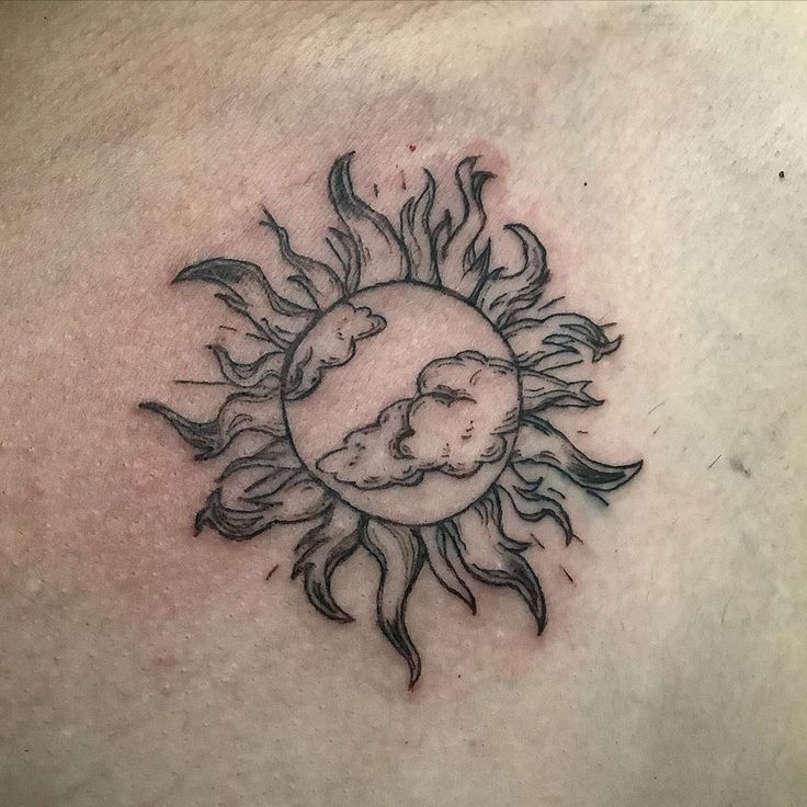 a sun and moon tattoo on the chest