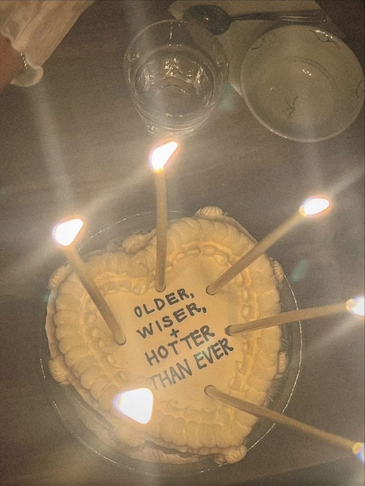 there is a cake with candles on it that says older, wiser, hotter, than ever