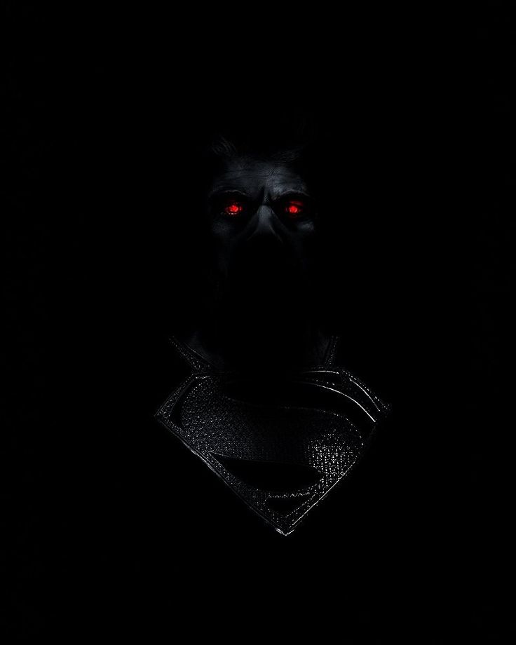 a man in the dark with red eyes and a black mask on his face is wearing a superman costume