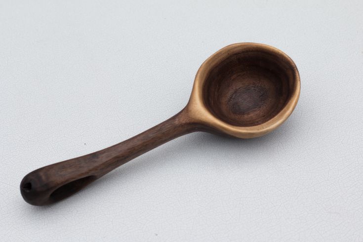 a wooden spoon sitting on top of a white table