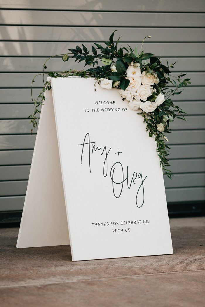 a sign with flowers and greenery on it that says, thank you for the wedding