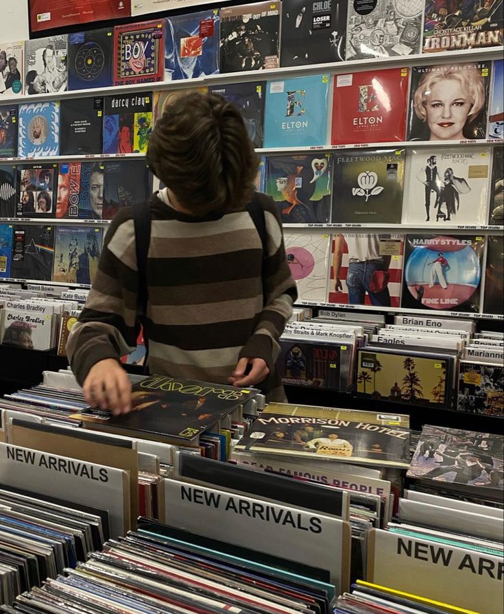 a man standing in front of a display of cds