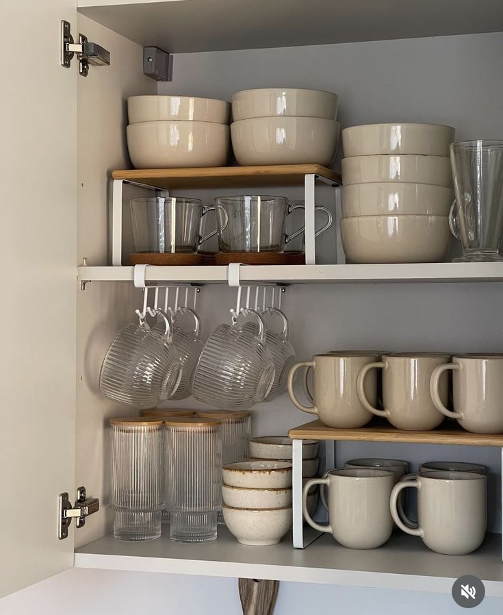 the shelves are filled with dishes and cups