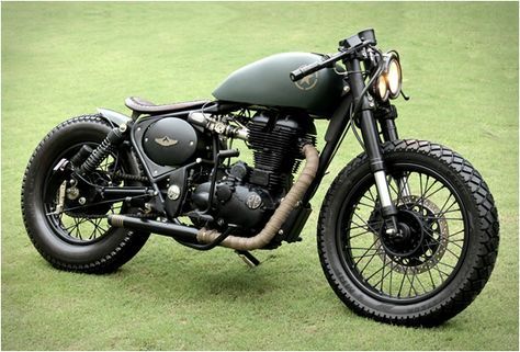 a motorcycle parked on top of a lush green field