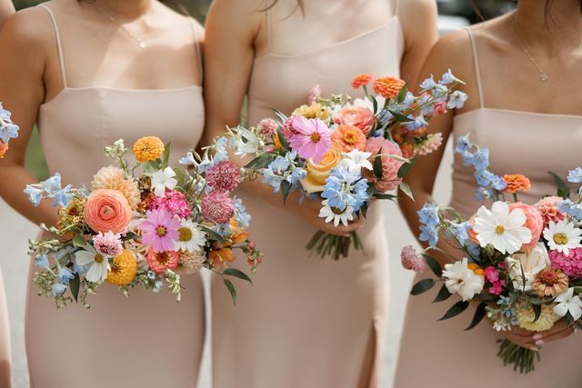 the bridesmaids are holding their bouquets together