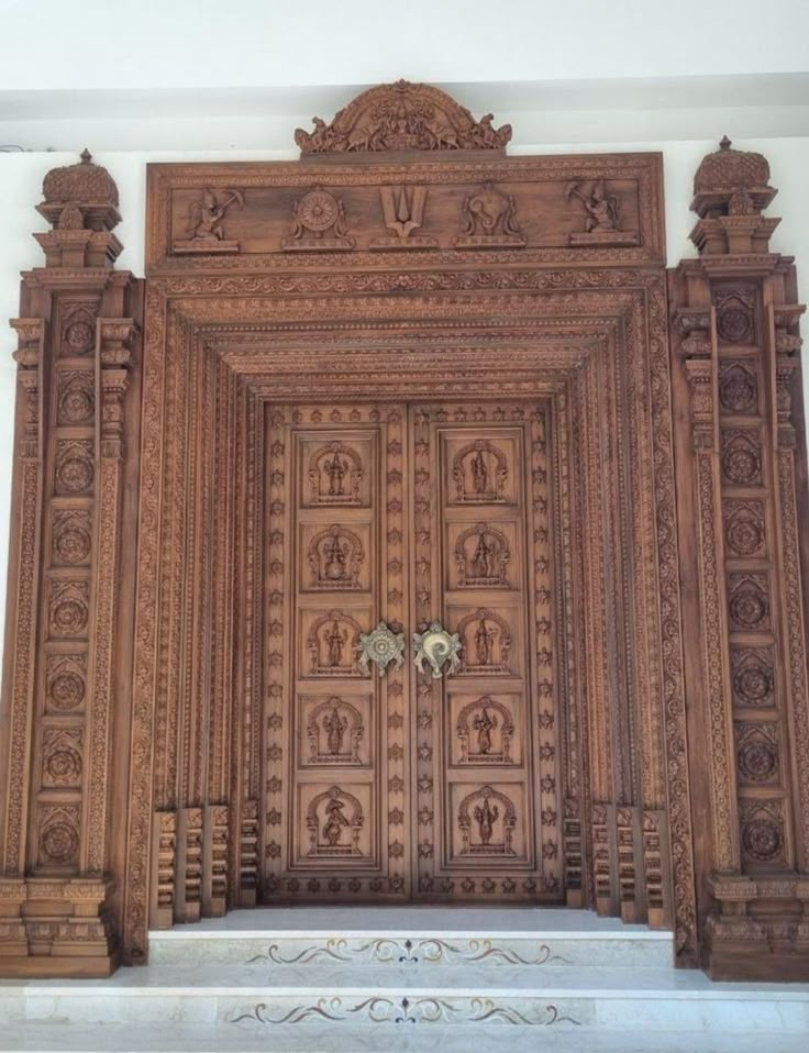 an intricately carved wooden door in a building